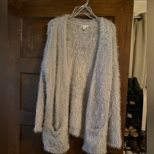 Super soft cardigan with silver, sparkly thread.  No buttons